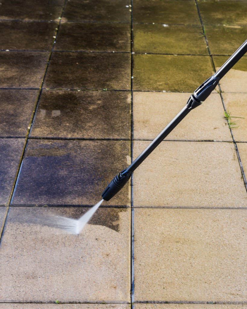 High pressure outdoor cleaning in Queensland showing mould removal from paving tiles