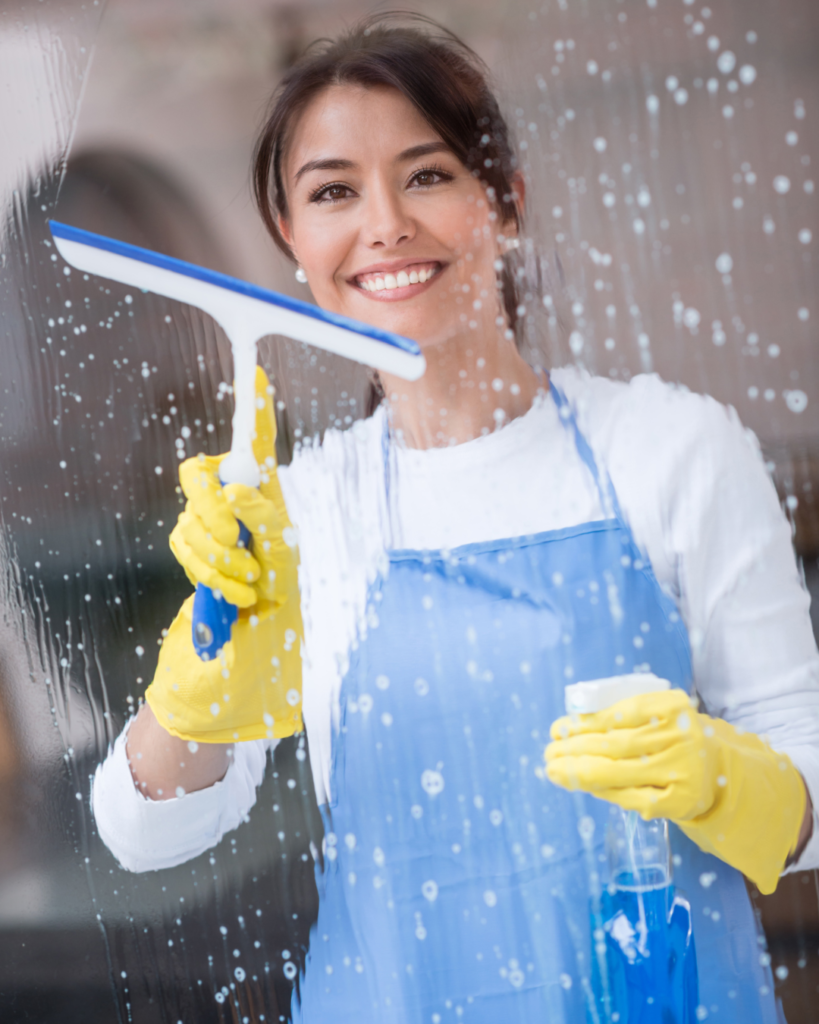 Professional Cleaning Services Queensland staff member cleaning glass with window cleaning tools